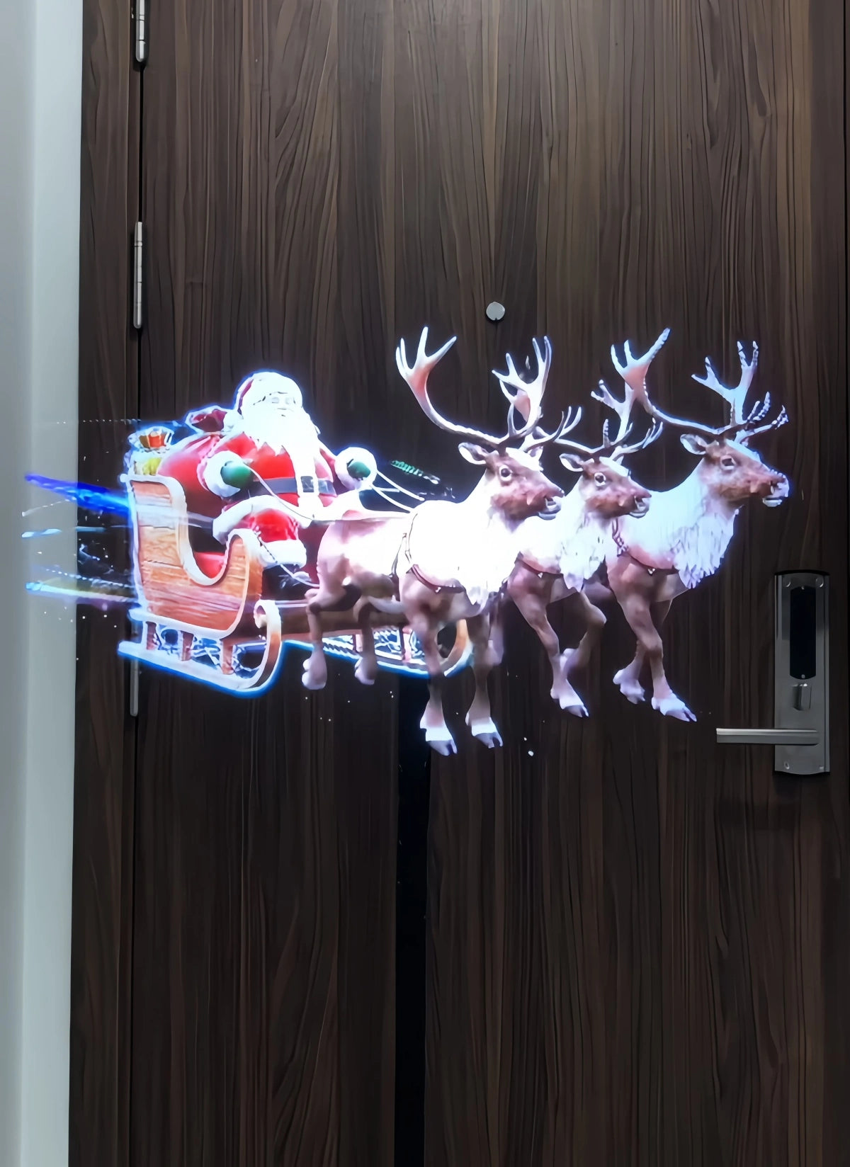3D holographic display projecting Santa Claus in a sleigh pulled by reindeer.