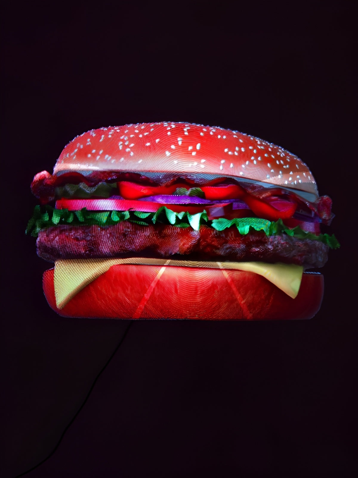 Holographic 3D burger projection displayed on a dark background.
