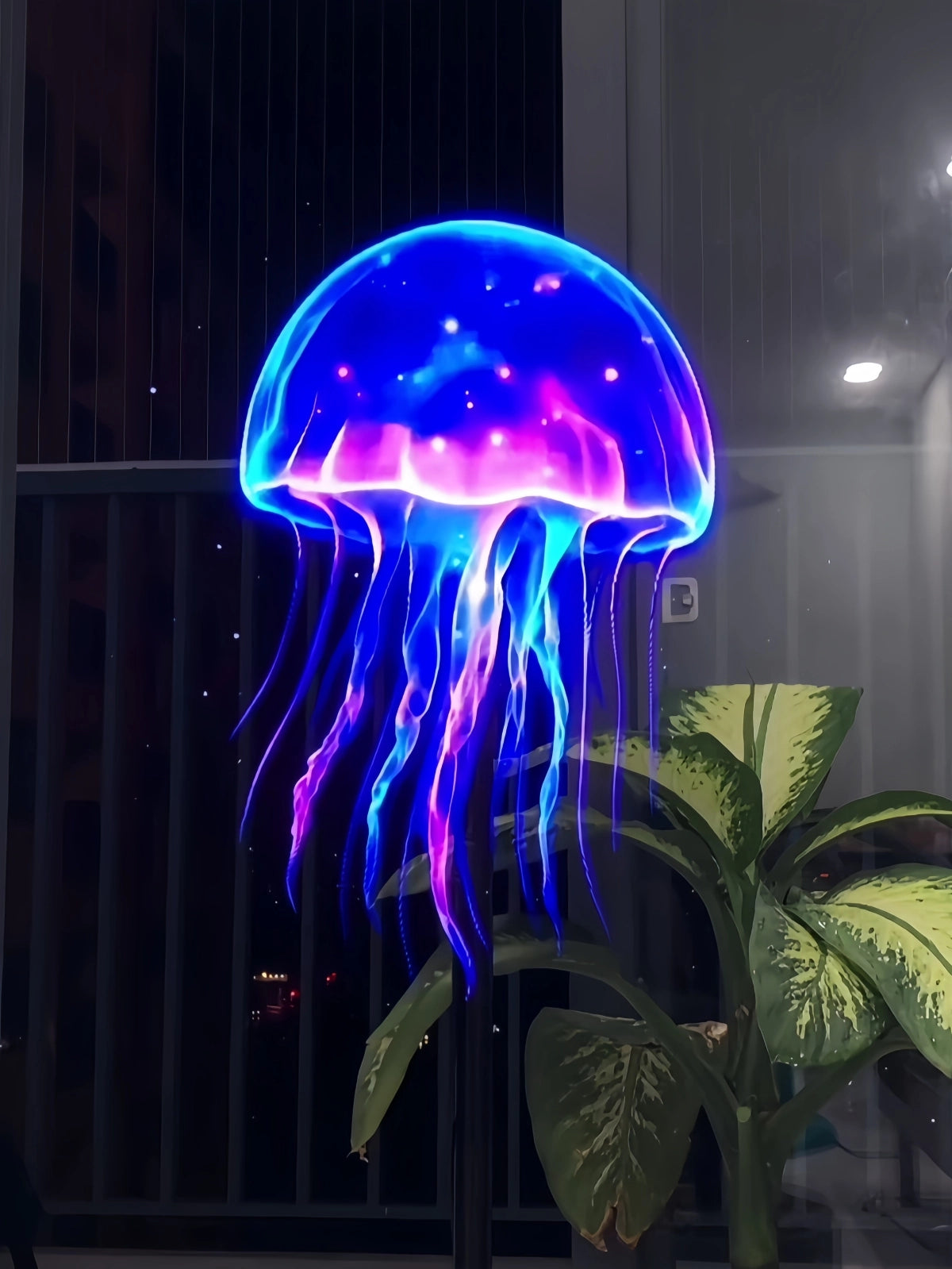 3D holographic jellyfish display shown on a HoloX fan with glowing blue and purple lighting.